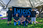 Amigos Car Club: Photograph of Amigos Car Club members with banner at Lowrider Council Event at Mission Bay