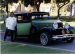 Chicano Brothers Car Club: Photograph of David Aguilar on his 25th wedding anniversary with a 1932 Willys-Knight car belonging to Rigo Reyes of Amigos Car Club