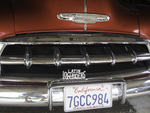 Latin Lowriders Car Club: Photograph of a 1952 Sedan Delivery belonging to Richie Burgos with club plaque